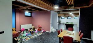 a room with a table and some stuffed animals in it at Residence by Carol&Vladi in Târgu Ocna
