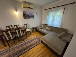 a living room with a couch and a table at Vila Ljubinka in Brežđe