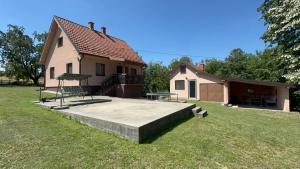 a house with a playground in the yard at Vila Ljubinka in Brežđe