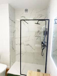 a shower with a glass door in a bathroom at La Calma apartamento muy cerca del centro in Cazorla +17 photos