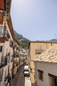 a view of a street with buildings and cars at La Calma apartamento muy cerca del centro in Cazorla