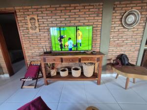 a television sitting on a table in a living room at Casa Brisas 17 in Luis Correia
