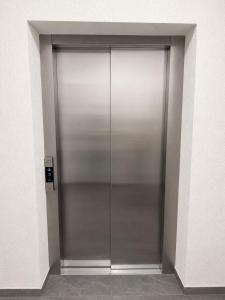 a large metal elevator door in a building at Miry Apartment in Târgu Neamț