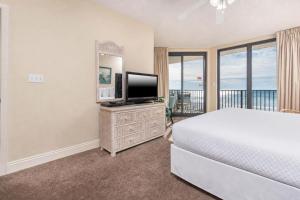 a bedroom with a bed and a flat screen tv at Phoenix X 317 in Orange Beach