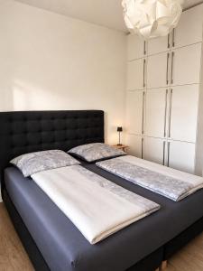 two beds sitting next to each other in a bedroom at Steinweg 7 Ferienwohnung in Kassel