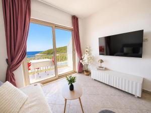 a living room with a view of the ocean at Apartments Marija Magdalena in Hvar