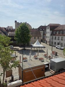 a courtyard with umbrellas and chairs and a white tent at Ferienwohnung Saskia in Hammelburg