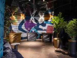 a room with potted plants and a wall with a mural at Mercure Tokyo Hibiya in Tokyo +113 photos