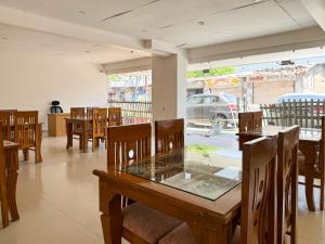 a dining room with wooden tables and chairs at Hotel Saathviik99 in Tehri-Garhwāl