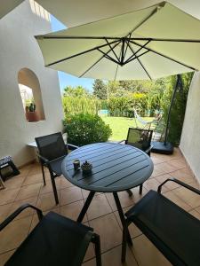 a patio with a table and chairs and an umbrella at Onda in Denia