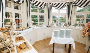 a large kitchen with a table with plates on it at Pension und Restaurant Gutshaus Kaltenhof in Kaltenhof