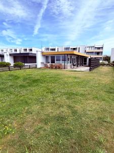 a building with a grass field in front of it at Utkiek in Fehmarn