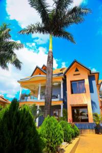 a palm tree in front of a building at KiGALI COMFORT AND CLASSIC STAY APARTMENT in Kigali