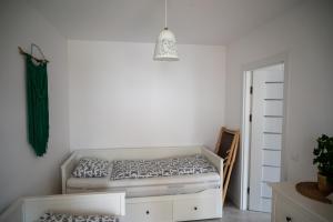 a bedroom with a bed and a pendant light at Apartament Roberto in Żarnowska +12 photos