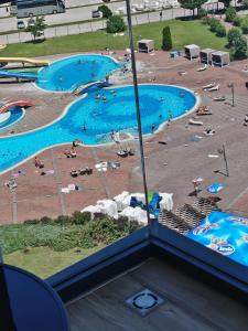 a view of a swimming pool from a hotel room at Modern Riverside Apartment in Sarajevo