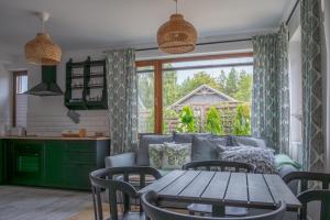 a living room with a couch and a table at Apartament Roberto in Żarnowska