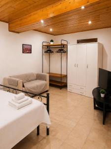 a living room with a bed and a couch at Varese City Center BnB in Varese