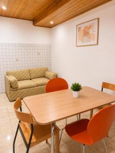 a living room with a table and chairs and a couch at Varese City Center BnB in Varese