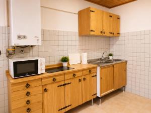 a kitchen with a microwave and a sink at Varese City Center BnB in Varese