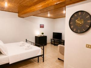 a room with a bed and a clock on the wall at Varese City Center BnB in Varese