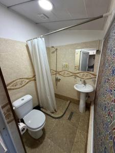 a bathroom with a toilet and a sink at Tbil Inn Hotel in Tbilisi City +98 photos