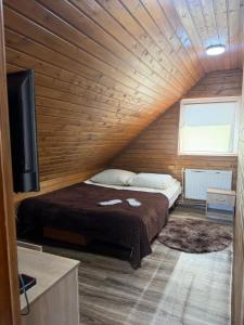 a room with a bed and a flat screen tv at Садиба Сойми in Soymy