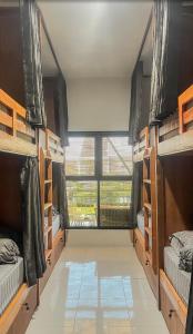 a room with bunk beds and a large window at TWD hostel in Malang