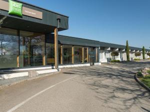 a building with a lot of windows on a street at Ibis Styles Colmar Nord in Colmar +69 photos
