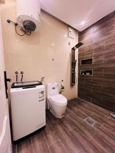 a small bathroom with a toilet and a light at شقق سكنية بابو ذر in Medina