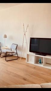 a living room with a flat screen tv sitting on a table at Casa Di Luce con Parcheggio Privato Interno Gratuito in Montesilvano