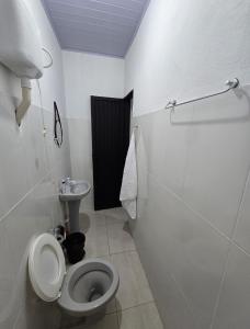 a bathroom with a toilet and a sink at Microcasa 6 in Lajeado +10 photos