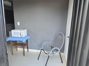 a room with two chairs and a microwave on a table at Microcasa 6 in Lajeado
