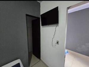 a room with a flat screen tv on a wall at Microcasa 6 in Lajeado