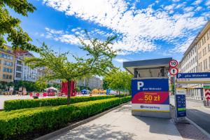 a gas station with a sign on the side of a street at Poznań Plac Wolności 6 Bond in Poznań