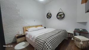 a bedroom with a bed and two mirrors on the wall at Casa Iacob in Sighişoara +5 photos