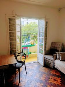 a living room with a door open to a patio at Pousada in Porto Alegre