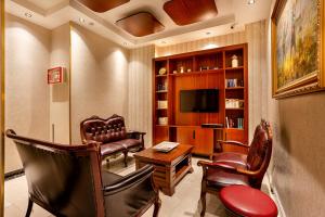 a living room with leather chairs and a television at The central hotel in Istanbul