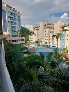 a view of a resort with a pool and palm trees at Porto Real Resort - Leisure and Fun in Mangaratiba