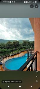 a view of a swimming pool from a building at Casa asud Dapoli in Dapoli +5 photos