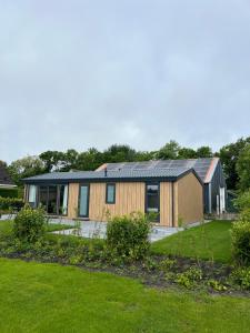 a house with solar panels on it in a yard at Green Flower in Renesse