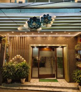 a front entrance to a building with plants in front at Hotel Samrat - A Boutique Hotel in Prayagraj