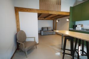 a kitchen with a table and a chair in a room at Casa do Javali 3 in Bragança