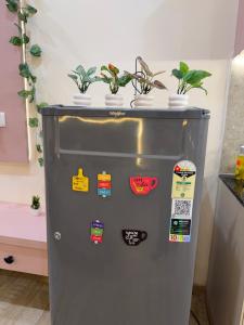 a refrigerator with potted plants on top of it at The cozy cave in Jaipur