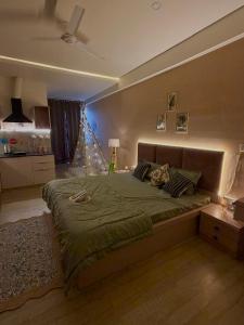 a bedroom with a large bed in a room at The cozy cave in Jaipur