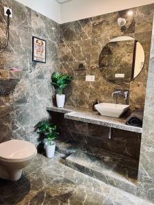 a bathroom with a sink and a toilet at The cozy cave in Jaipur +20 photos