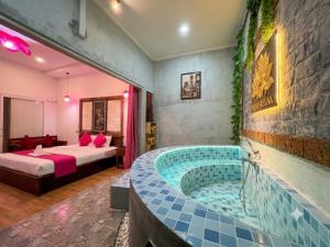 a hotel room with a jacuzzi tub in a bedroom at Angkor Rithy Residence in Siem Reap