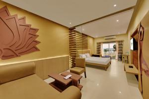a hotel room with a bed and a couch at Jiwan Hotels in Rāmeswaram