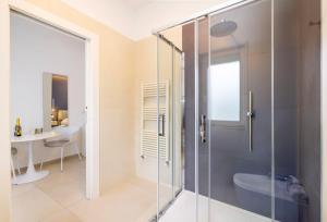 a bathroom with a glass shower and a sink at Le Stagioni Rooms in Vieste
