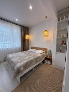 a bedroom with a large bed and a window at Wings Zen in Bosteri