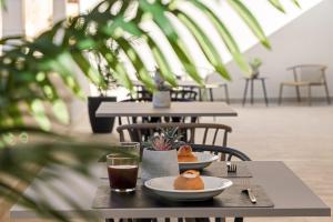 a table with two plates of food and drinks on it at Dimora degli archi in Terrasini